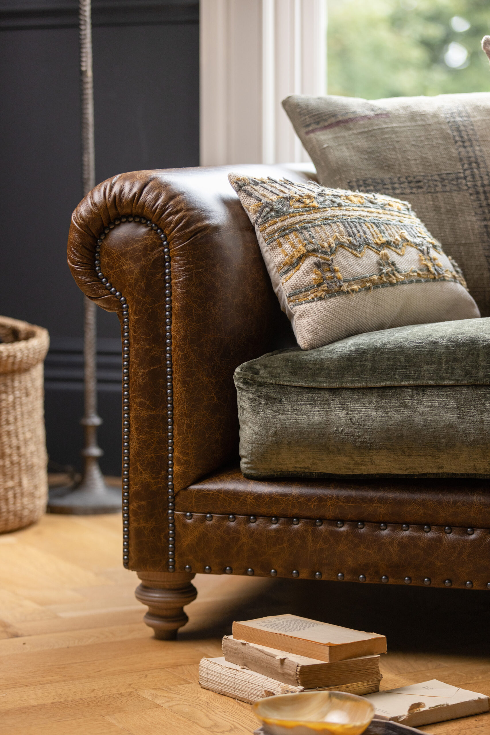 Close-up of Tetrad craftsmanship showing leather upholstery, stud detailing and fabric cushions